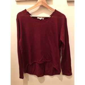 Burgundy knit top with split back detail.